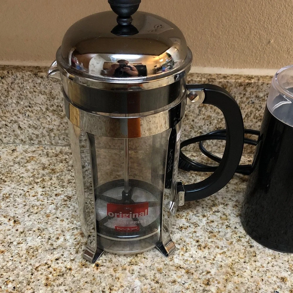 Black Electric Coffee Grinder with French Press and Orange Travel Mug